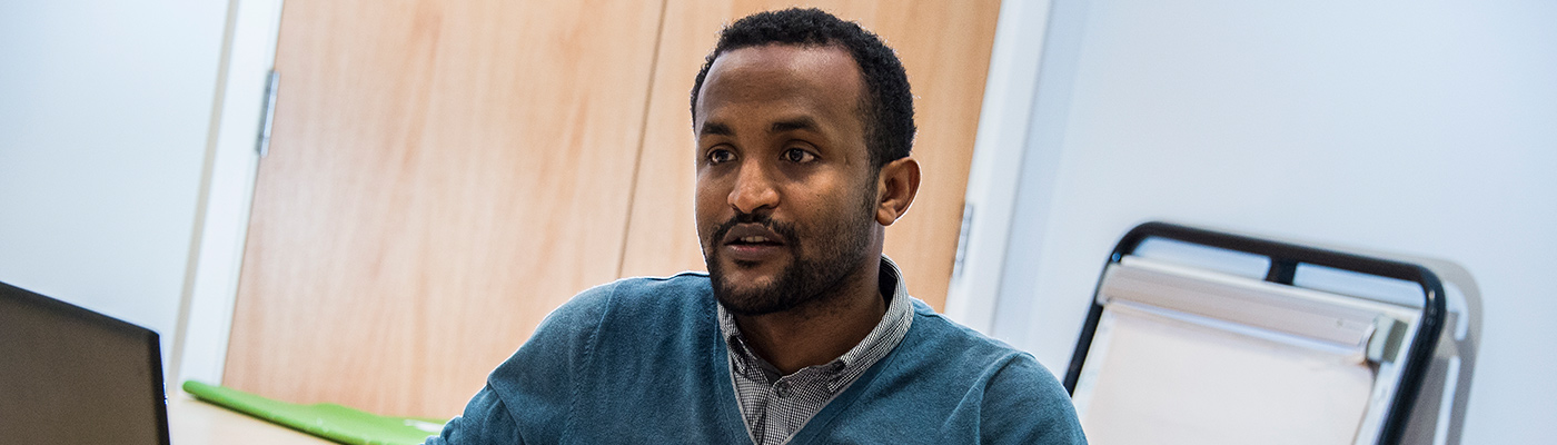 Student sat at desk with laptop