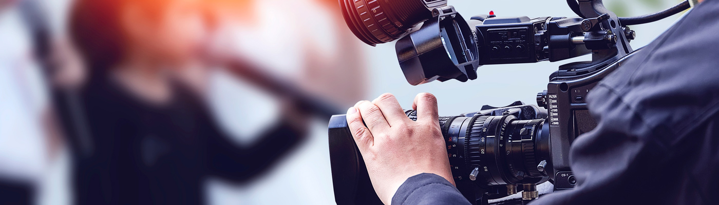 Operator's hand adjusting video camera