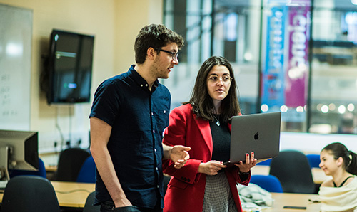 Male and female researcher having a discussion