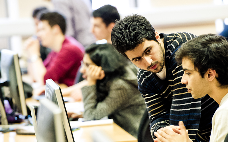 A computer science teacher and student in discussion