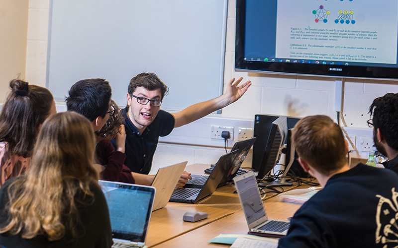 A student in conversation with a younger student
